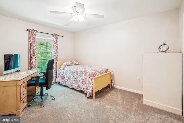 carpeted bedroom with a ceiling fan and baseboards