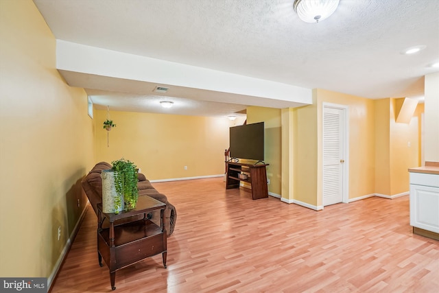 interior space featuring light wood-type flooring and baseboards