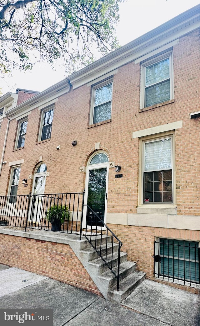 view of property with brick siding