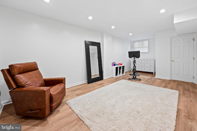 workout area with light wood-type flooring, baseboards, and recessed lighting