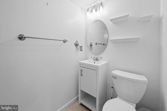 bathroom featuring toilet and vanity