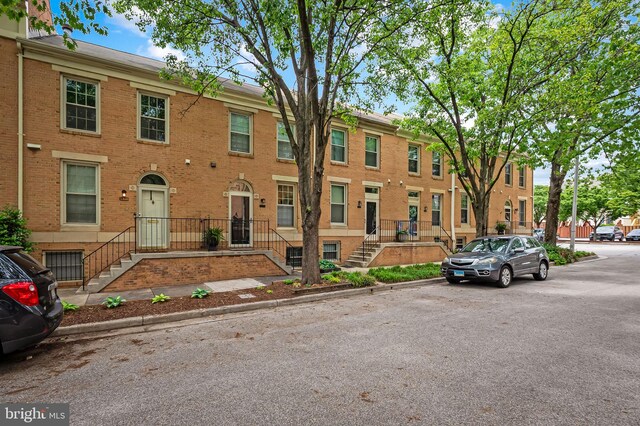 view of front of house with brick siding and a residential view