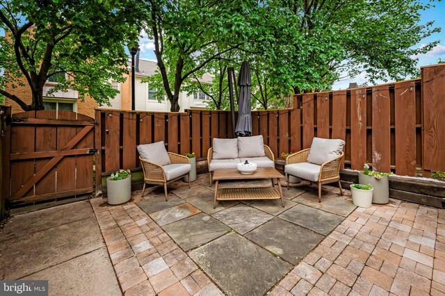 view of patio with a gate, a fenced backyard, and outdoor lounge area