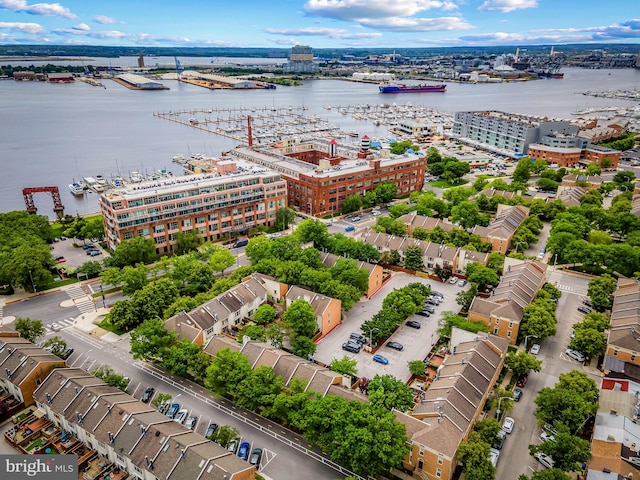 aerial view of a nearby body of water, a notable bridge, and a marina
