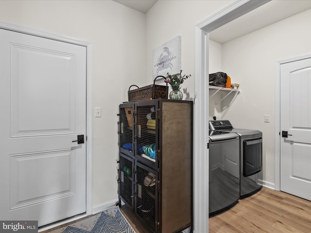 35040 Dundee St Unit 133, Frankford, DE 19945 - laundry room with washing machine and clothes dryer, baseboards, laundry area, and light wood-style flooring