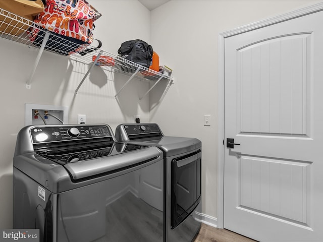 35040 Dundee St Unit 133, Frankford, DE 19945 - laundry area featuring washer and clothes dryer, laundry area, baseboards, and light wood-type flooring