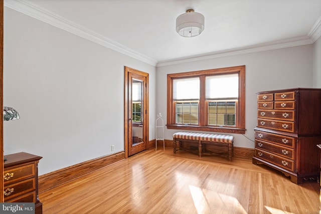 bedroom featuring baseboards, ornamental molding, and light wood-style flooring