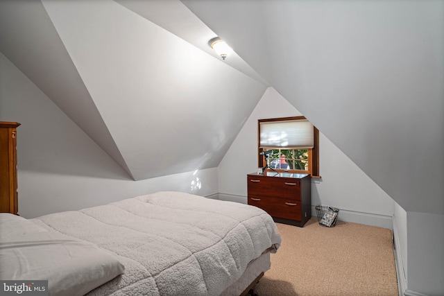 carpeted bedroom with lofted ceiling