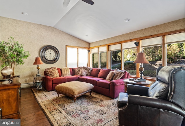 living area with a ceiling fan, a baseboard heating unit, lofted ceiling, and hardwood / wood-style floors