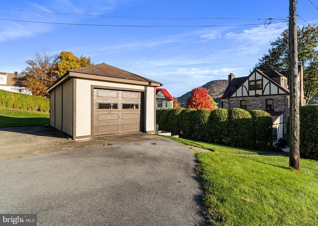detached garage featuring aphalt driveway