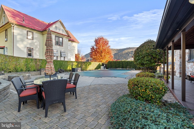 view of pool with outdoor dining area, a patio area, fence, and a fenced in pool