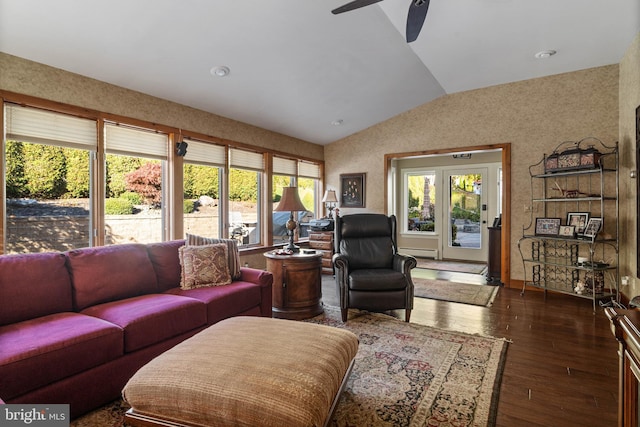 living room featuring wood-type flooring, a ceiling fan, vaulted ceiling, and baseboard heating