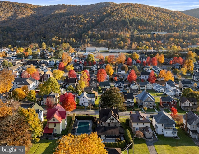 bird's eye view featuring a wooded view, a residential view, and a mountain view