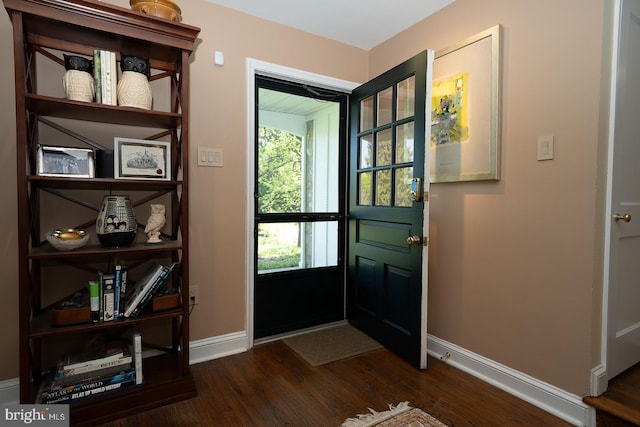 entryway featuring baseboards and dark wood finished floors