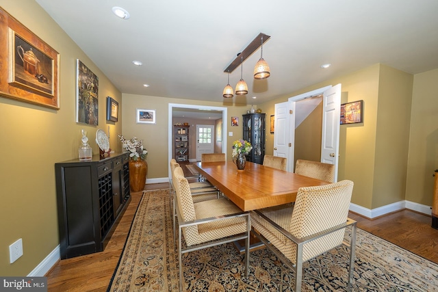 dining space with baseboards, recessed lighting, and wood finished floors