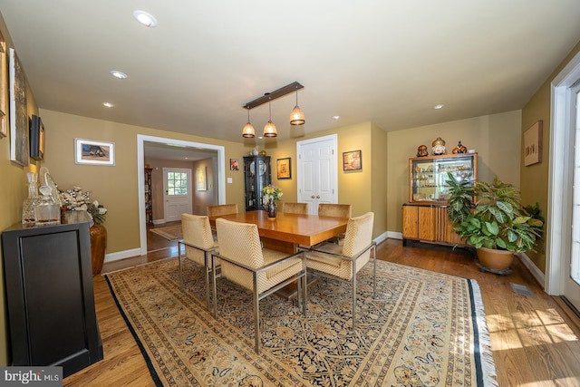 dining area featuring recessed lighting, baseboards, and wood finished floors