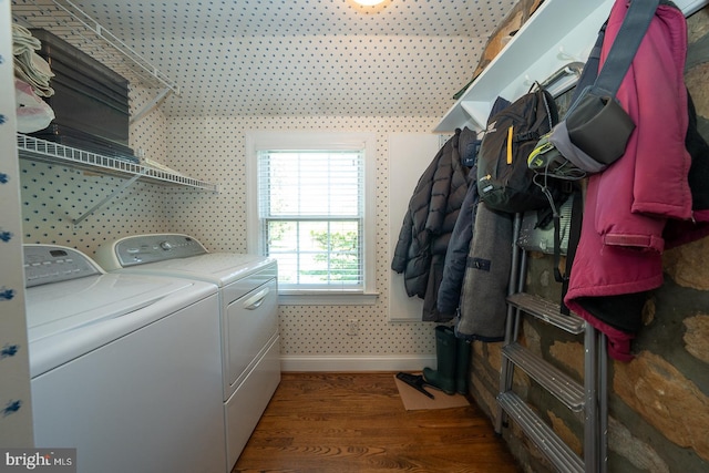 laundry room featuring laundry area, baseboards, washing machine and dryer, and wood finished floors