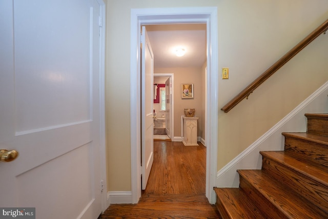 interior space with stairway, baseboards, and wood finished floors