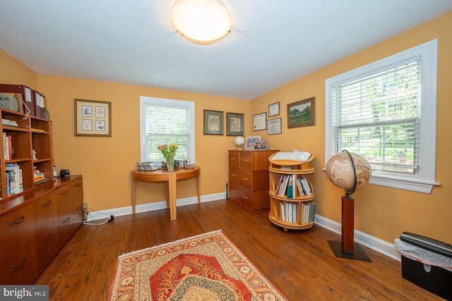 sitting room with baseboards, wood finished floors, and visible vents