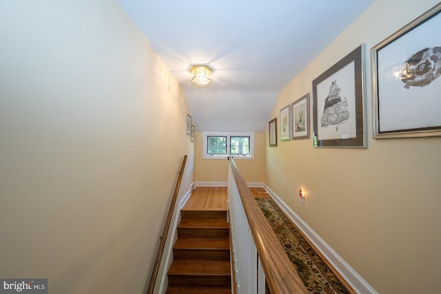 stairway featuring baseboards and wood finished floors