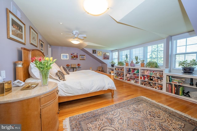 bedroom featuring multiple windows, light wood-type flooring, and visible vents