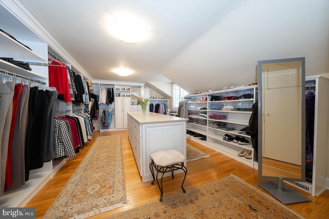 walk in closet featuring lofted ceiling and light wood-type flooring