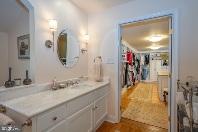 bathroom with vanity and wood finished floors