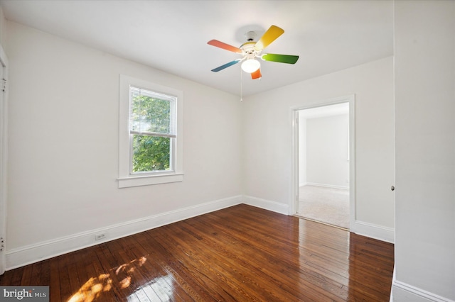 unfurnished room with baseboards, a ceiling fan, and hardwood / wood-style flooring