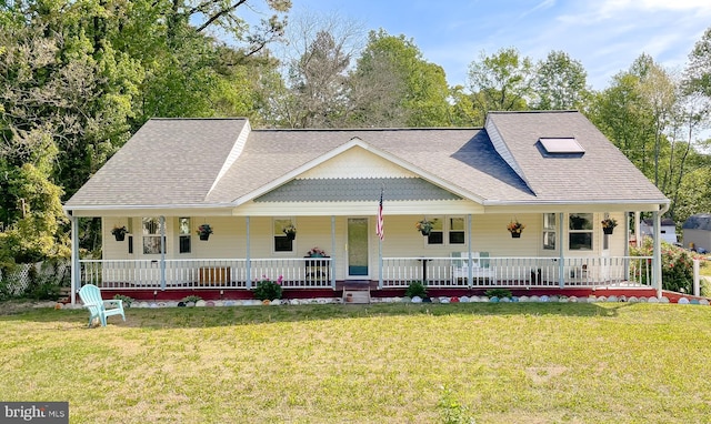 farmhouse with covered porch, a shingled roof, and a front lawn