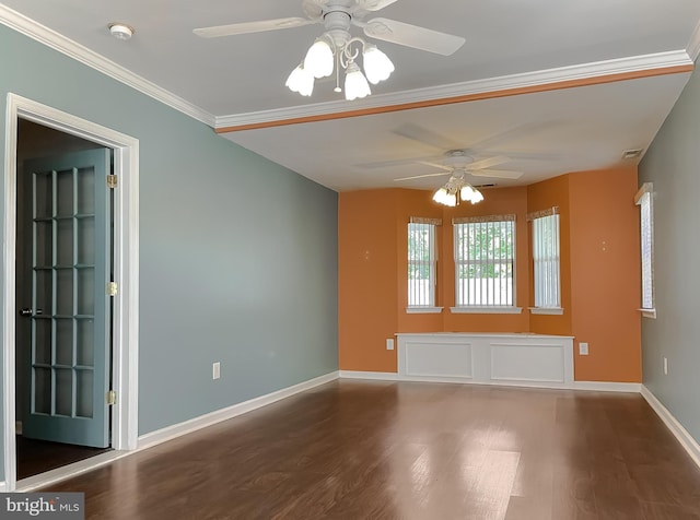 spare room featuring a ceiling fan, baseboards, wood finished floors, visible vents, and ornamental molding