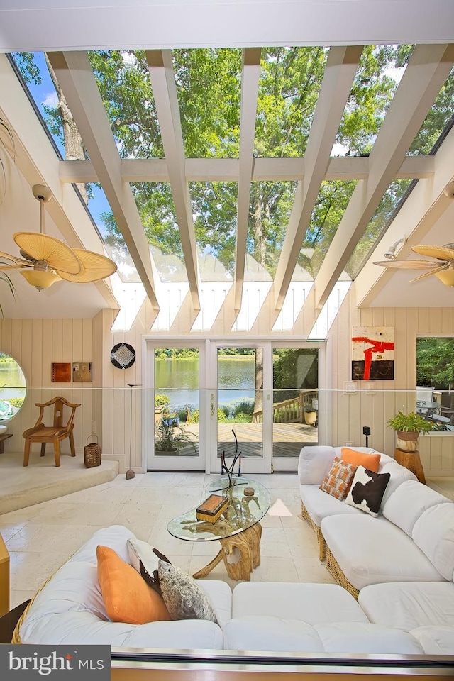 11566 Lake Newport Rd, Reston, VA 20194 - living room with wood walls, a water view, and a skylight