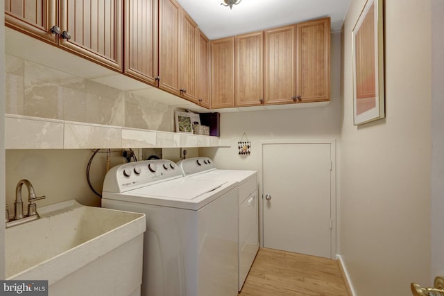 11566 Lake Newport Rd, Reston, VA 20194 - washroom featuring independent washer and dryer, cabinet space, and light wood-type flooring