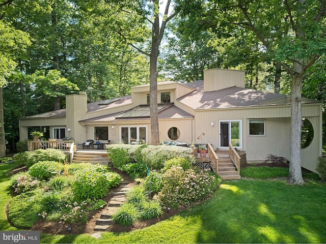 11566 Lake Newport Rd, Reston, VA 20194 - rear view of house with a deck, a lawn, roof with shingles, and a chimney
