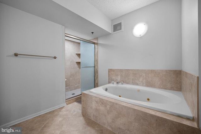 bathroom featuring tile patterned flooring, a textured ceiling, a jetted tub, visible vents, and a stall shower
