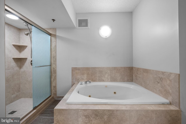 full bathroom featuring visible vents, a textured ceiling, a tub with jets, and a shower stall