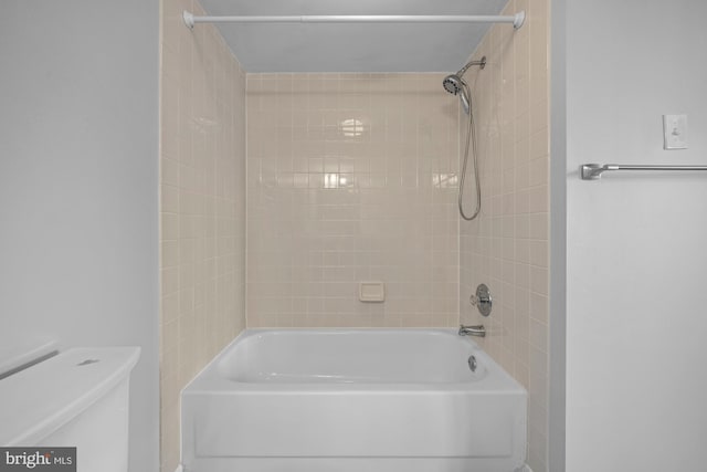 bathroom featuring shower / bathing tub combination and toilet