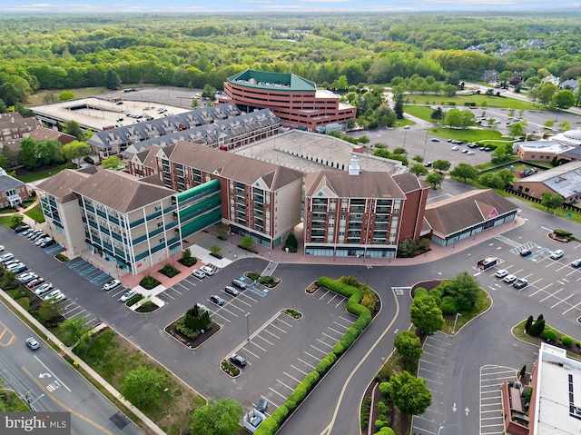drone / aerial view featuring a wooded view