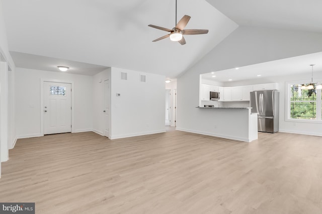 unfurnished living room with visible vents, high vaulted ceiling, baseboards, ceiling fan with notable chandelier, and light wood-style floors