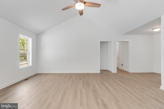 interior space with light wood finished floors, a ceiling fan, baseboards, lofted ceiling, and visible vents