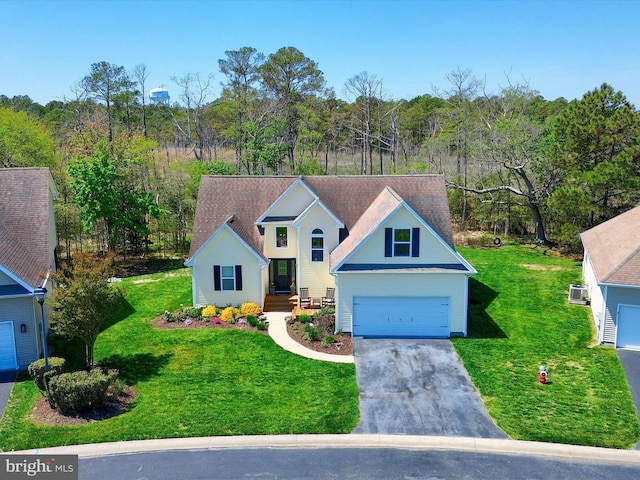 view of front of home featuring a garage, driveway, and a front yard