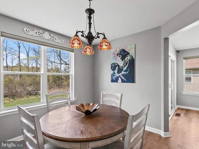 dining room featuring baseboards and wood finished floors