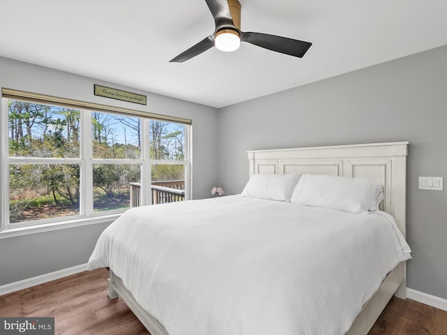 bedroom featuring baseboards, a ceiling fan, and wood finished floors