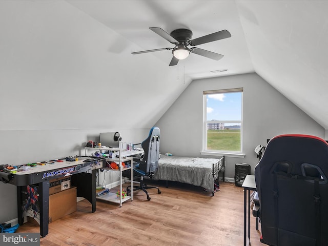 bedroom featuring a ceiling fan, visible vents, wood finished floors, and lofted ceiling