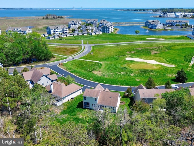 drone / aerial view featuring a water view, golf course view, and a residential view