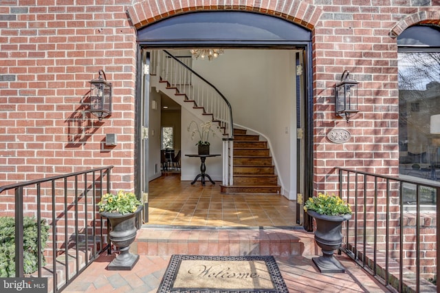 property entrance featuring brick siding