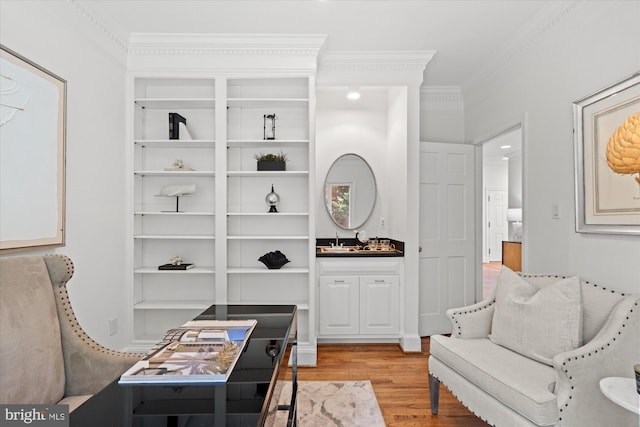 3233 Ellicott St NW, Washington, DC 20008 - sitting room with light wood-style flooring, crown molding, and built in shelves