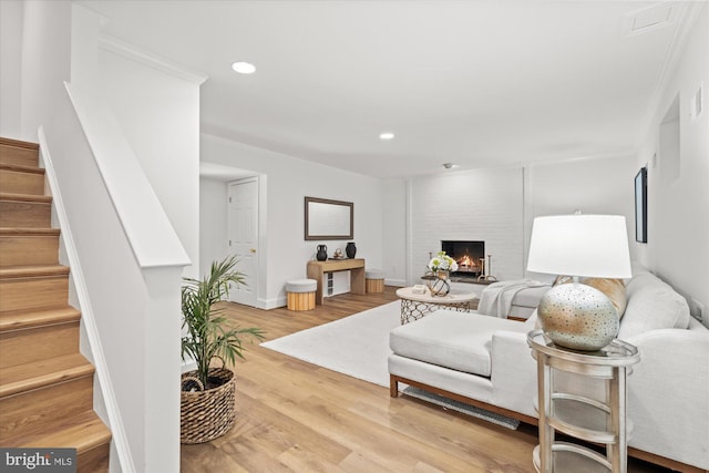 3233 Ellicott St NW, Washington, DC 20008 - living room with stairs, a brick fireplace, recessed lighting, and wood finished floors