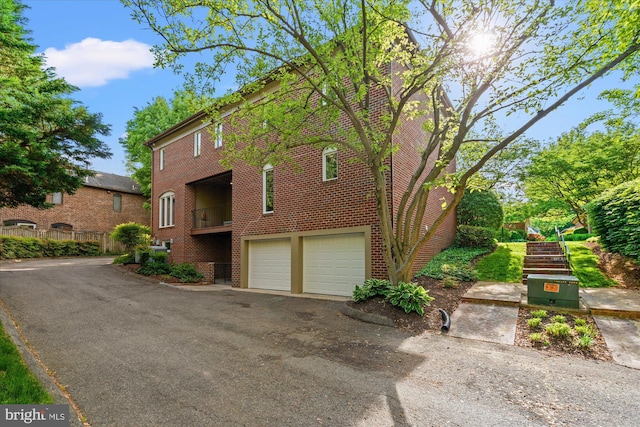 3233 Ellicott St NW, Washington, DC 20008 - view of side of property with driveway, brick siding, and an attached garage