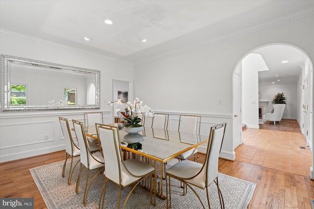 3233 Ellicott St NW, Washington, DC 20008 - dining area with ornamental molding, light wood-style flooring, and arched walkways