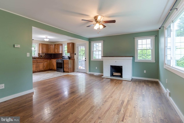 1724 E Branch Rd, State College, PA 16801 - unfurnished living room featuring ceiling fan, baseboards, a brick fireplace, light wood-style flooring, and ornamental molding